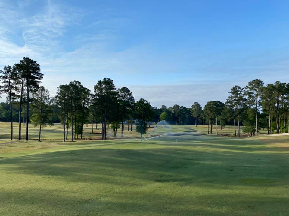 Golf course fairway with trees